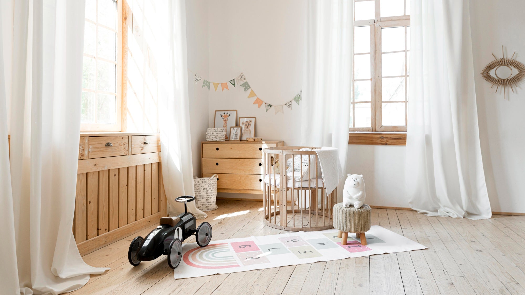 Cozy baby nursery with a crib, wooden dresser, and neutral-toned décor in a rustic room design — warm lighting complements the modern nursery setup.