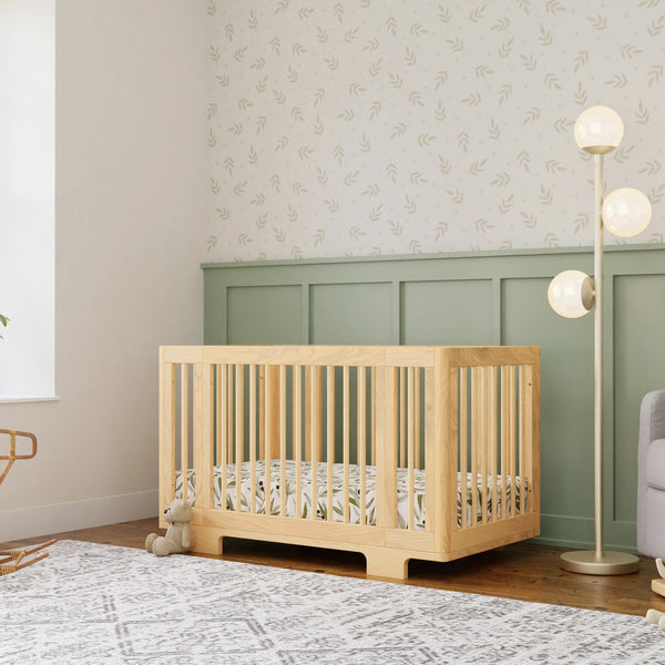 Babyletto Yuzu crib displayed in a cozy bedroom setting, highlighting its modern design, natural wood finish, and versatile functionality for a stylish and safe nursery space.  