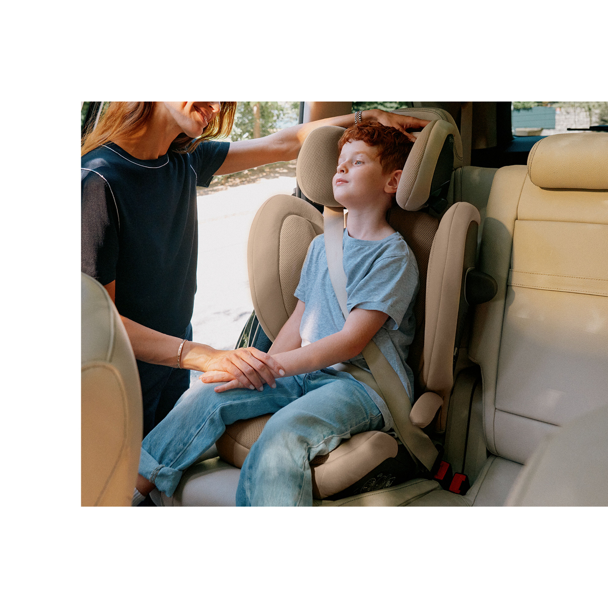 Toddler sitting comfortably in the Cybex Solution G2 booster car seat, showing safe and secure fit. 