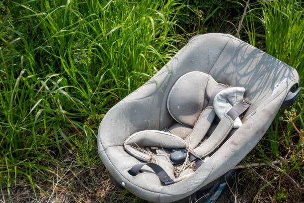 Baby car seat with visible signs of wear and aging, indicating car seat expiration.