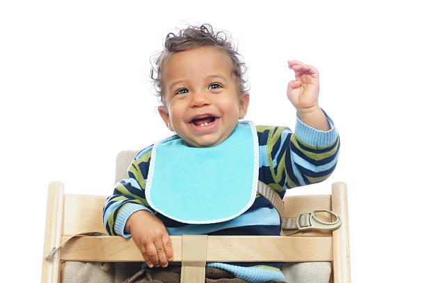 Smiling baby wearing a blue baby bib.