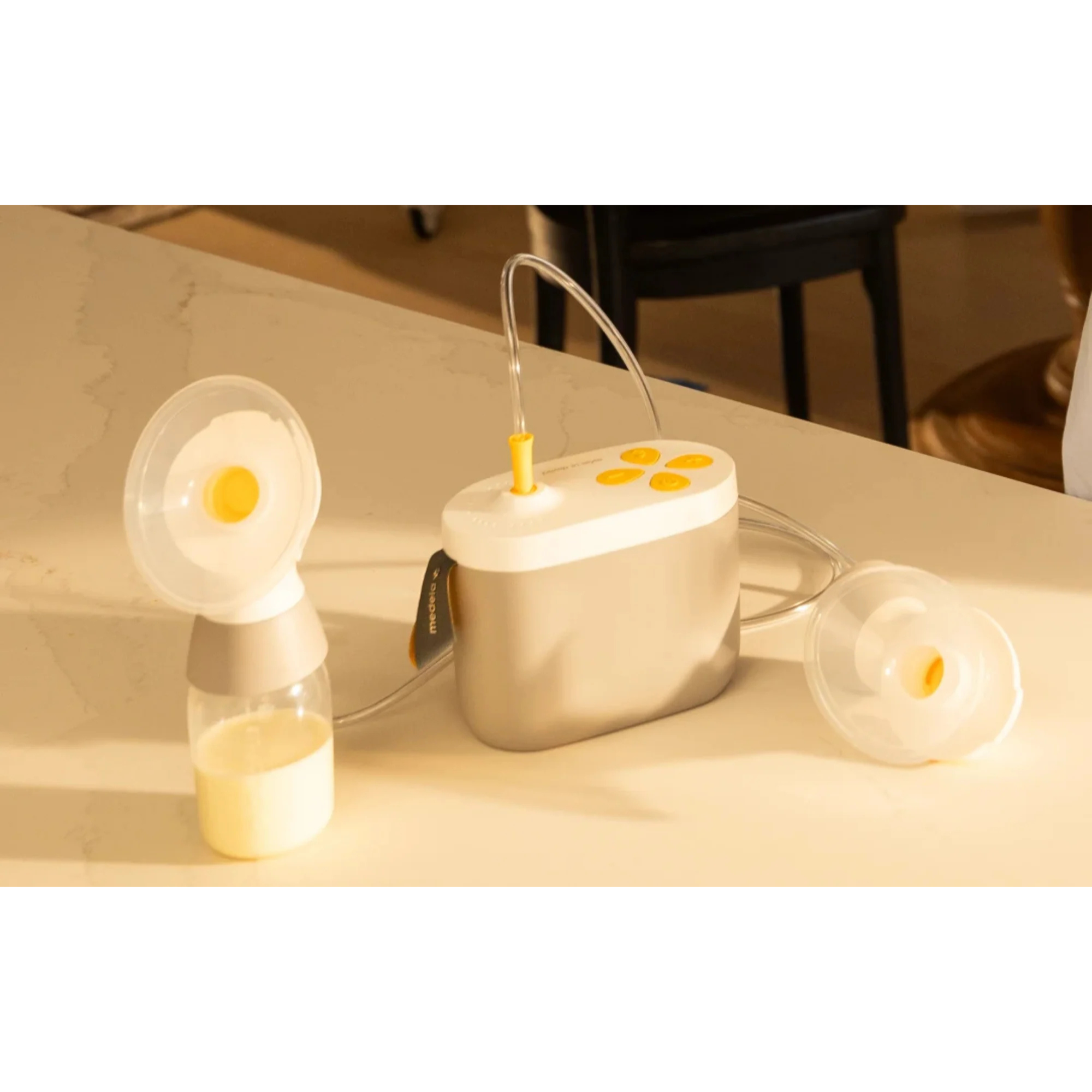 MEDELA Pump in Style Pro+ Traditional Breast Pump with collected breast milk, showcasing efficient double pumping.