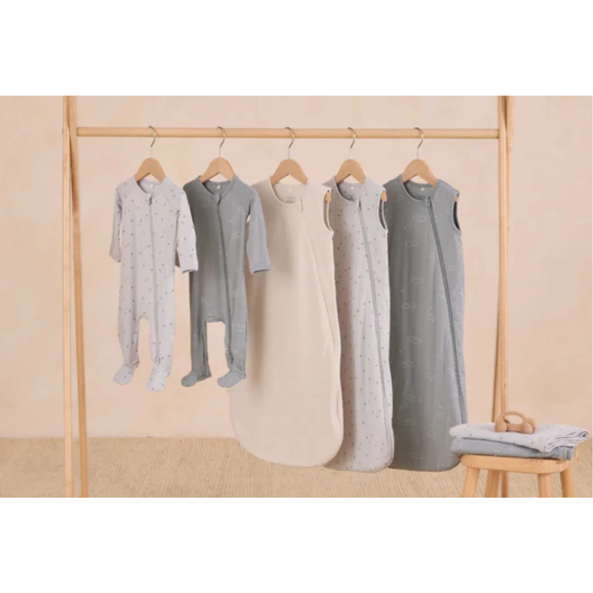 Quincy Mae baby clothing hanging on display, showcasing soft organic fabrics and timeless boutique styles for everyday comfort. 
