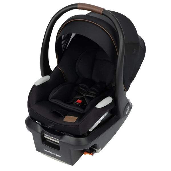 Maxi-Cosi Mico infant car seat in black with brown leather handle, five-point harness, extendable canopy, and stay-in-car UAS base.