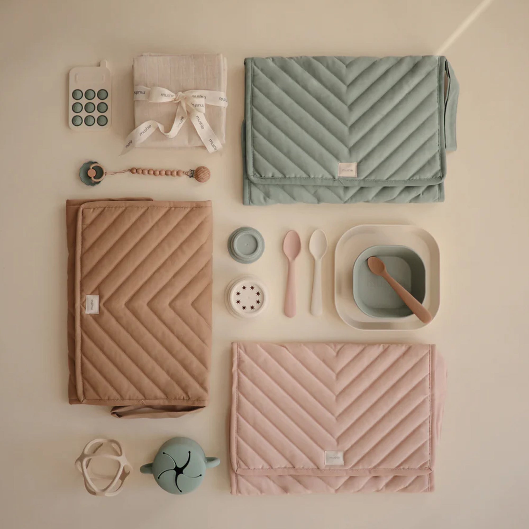 Mushie changing pad in soft neutral colors with a sleek contoured shape. Wipeable, waterproof & modern design. 