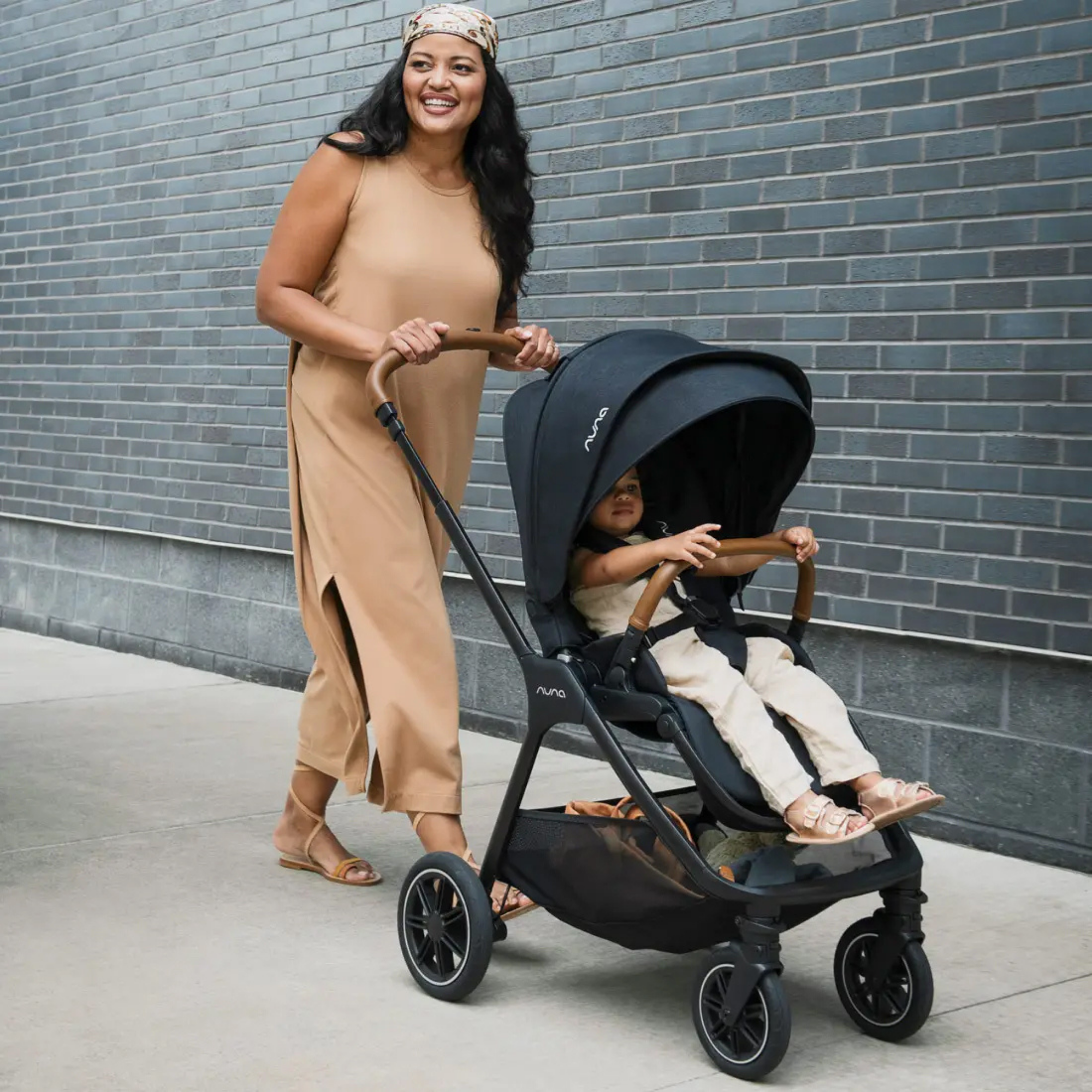 Nuna TRIV Next stroller, designed for smooth walks and happy moments as mom strolls comfortably with her baby. 