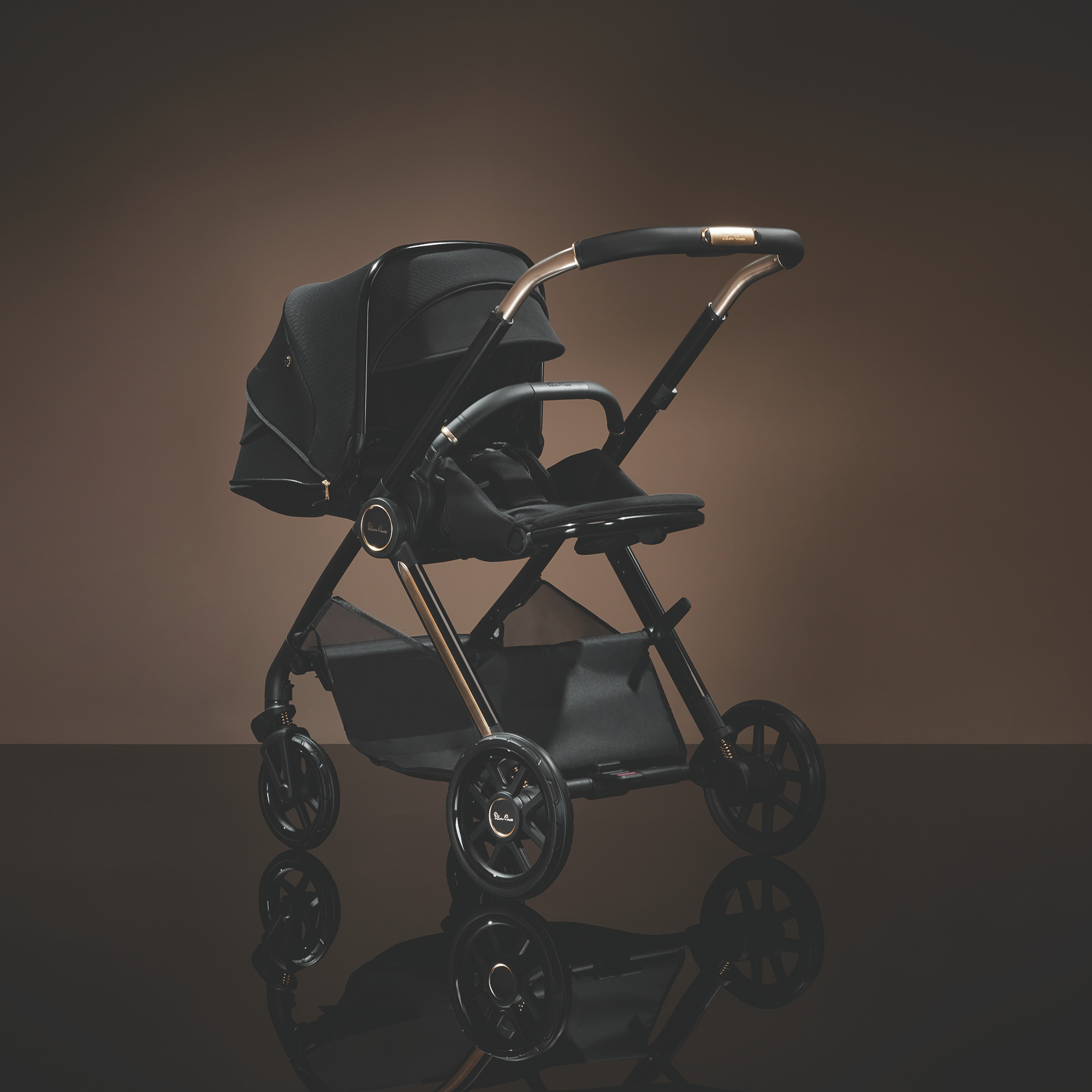 Silver Cross Reef 2 stroller shown in recline mode, highlighting comfort, smooth lines, and premium design in a studio setting. 