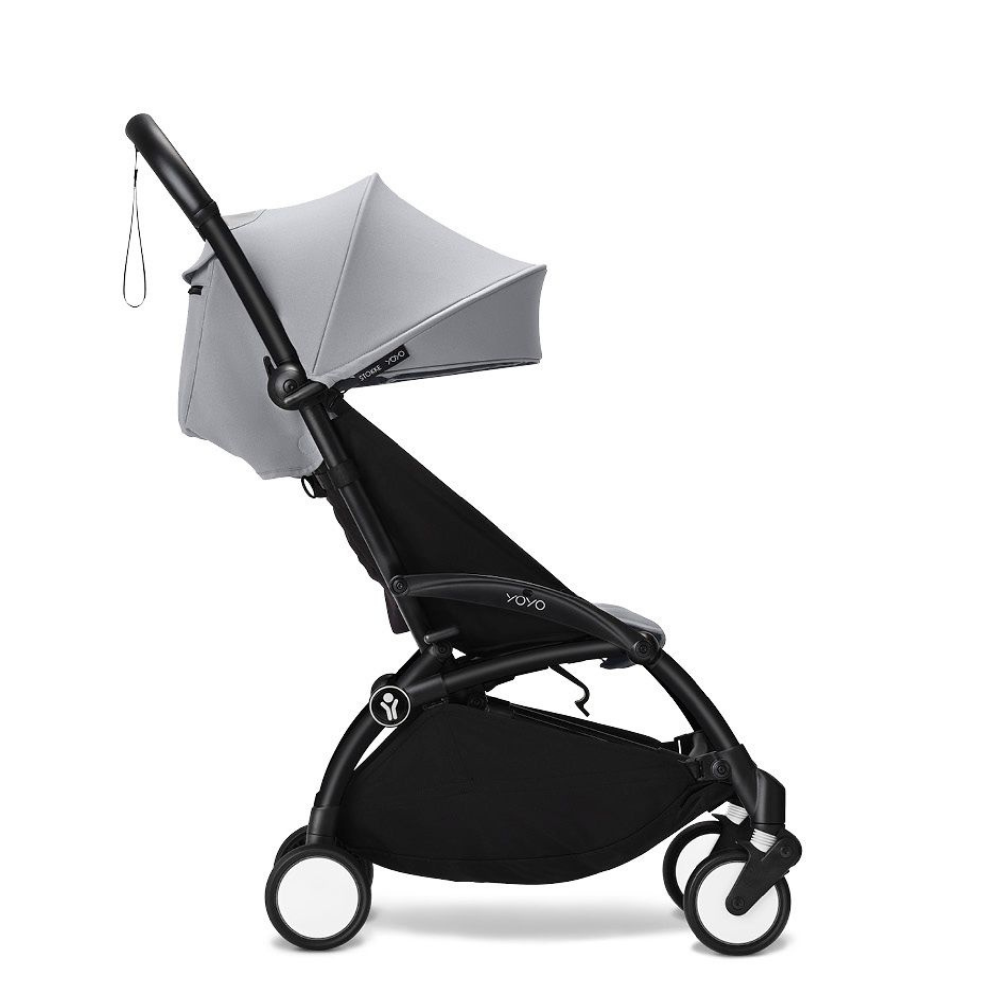 Stokke YOYO complete stroller in Stone colorway, angled product view showing frame, folded seat unit, and shoulder carry strap.