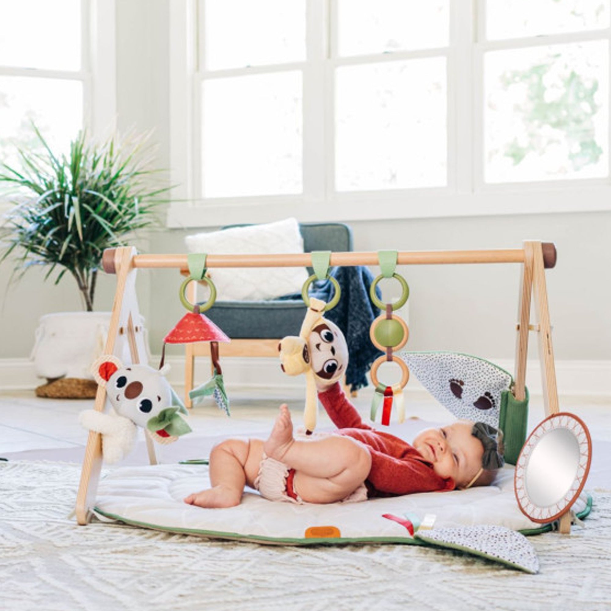 Baby enjoys playful learning with Tiny Love Boho Chic Gymini, boosting sensory skills, motor development, and curiosity