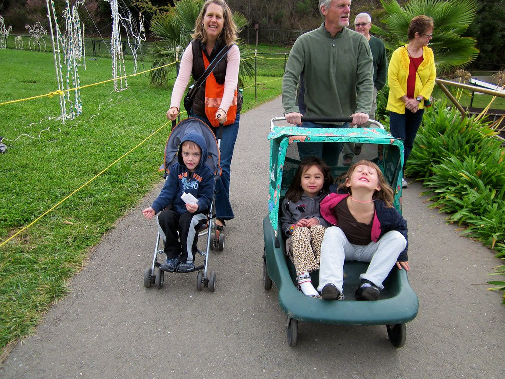 Big kids enjoying a ride in strollers.