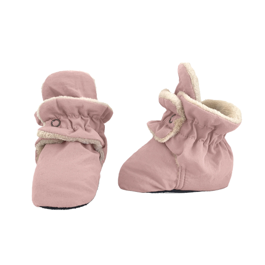 Pair of soft pink baby booties with elastic cuffs and cozy lining, designed to keep little feet warm and secure.