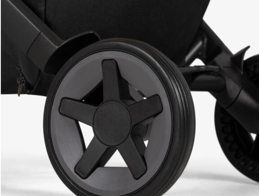  Side view of a dark Stokke YOYO³ stroller wheel and chassis, illustrating the compact folding frame used with the Joolz Newborn Pack