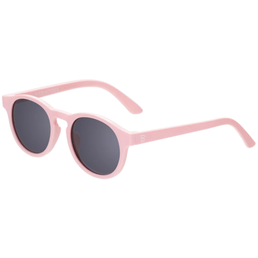 Babiators Keyhole kids sunglasses in ballerina pink with round grey lenses and lightweight flexible frame for comfortable daily sun protection.