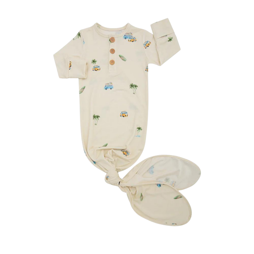 Cream baby short-sleeve bodysuit with matching booties, scattered pastel print, laid flat on white background for product view.