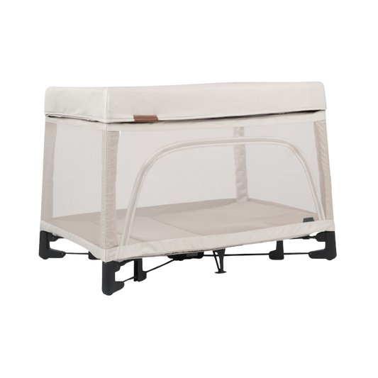Beige UPPAbaby Remi playard with mesh sides, sturdy frame, and changing station attachment, designed for easy diaper changes and travel.