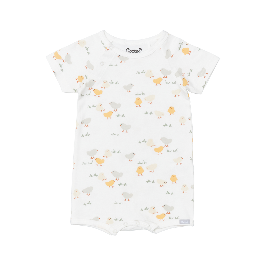 Coccoli infant romper in breathable white modal fabric, short sleeves and playful yellow chick pattern, designed as a soft one-piece.