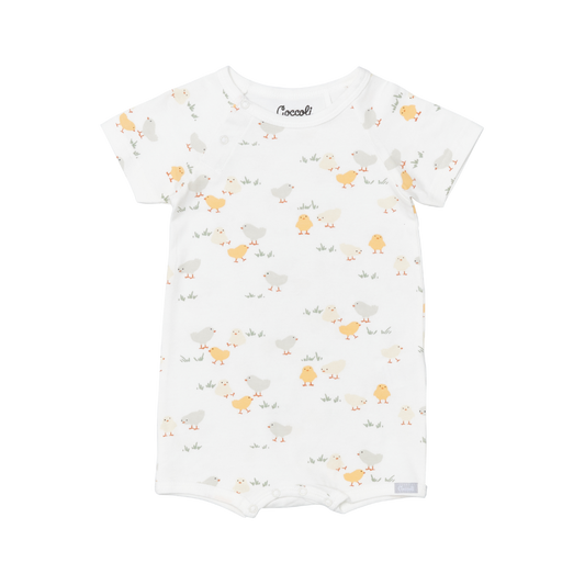 Coccoli infant romper in breathable white modal fabric, short sleeves and playful yellow chick pattern, designed as a soft one-piece.