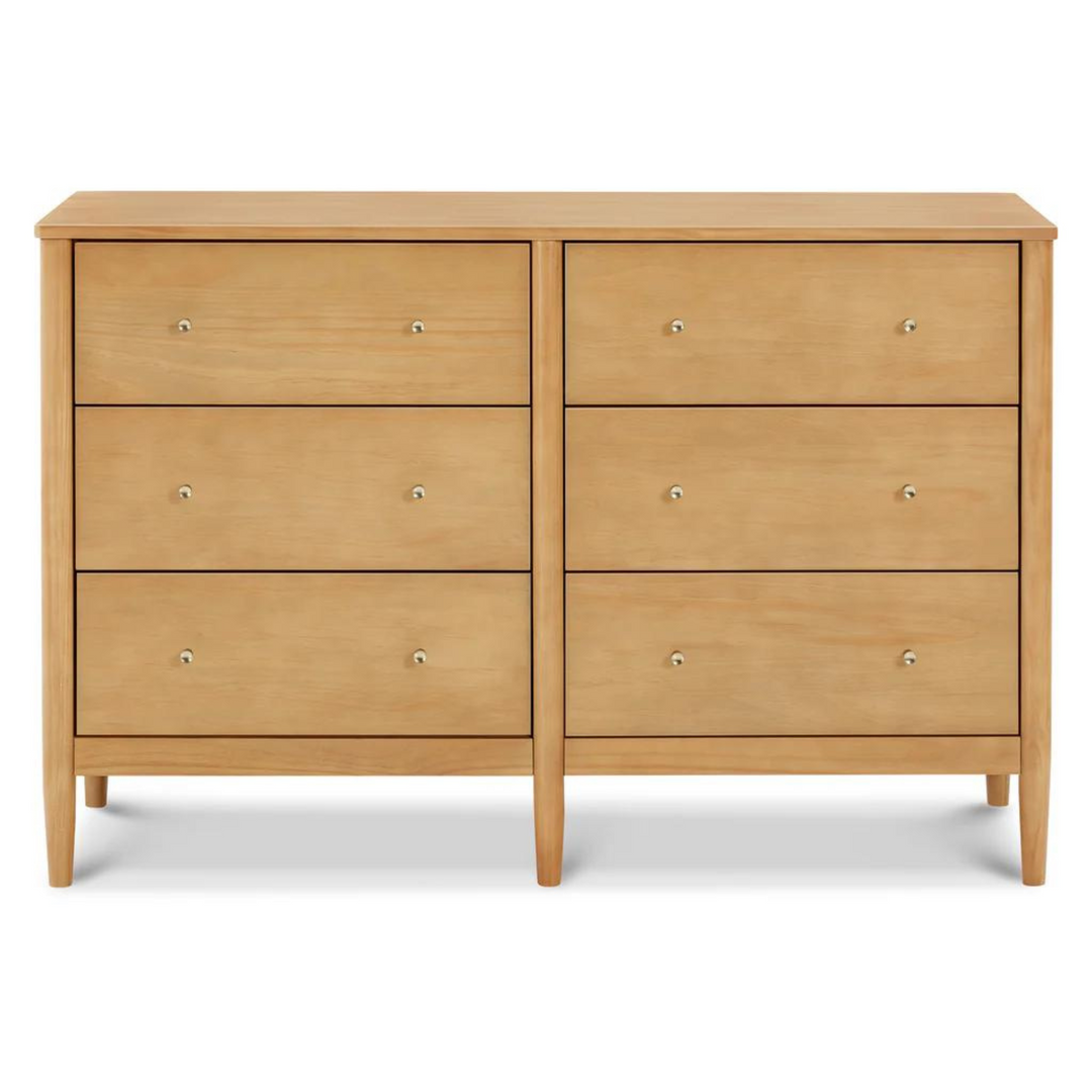 DaVinci Frem 6-drawer dresser in warm honey finish with clean modern lines, round knobs, and tapered legs for nursery storage.