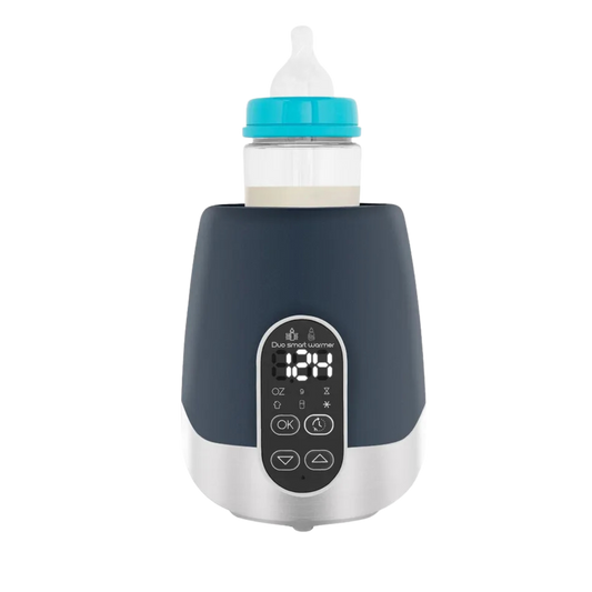 Black and silver digital baby bottle warmer with front display showing temperature, holding a baby bottle securely on top.