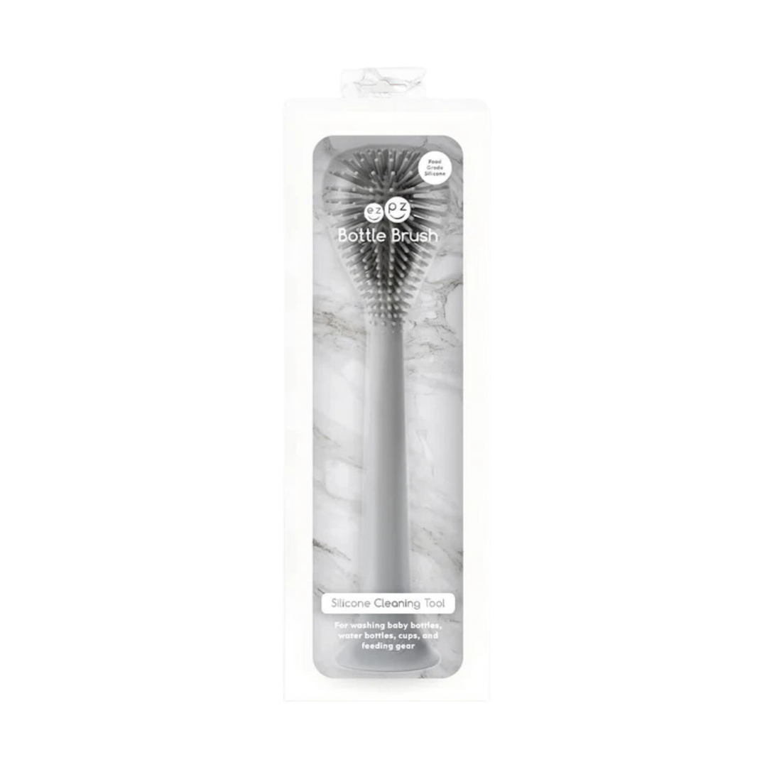 Black silicone baby spoon in clear packaging, featuring soft tip and ergonomic handle designed for gentle feeding and easy grip.