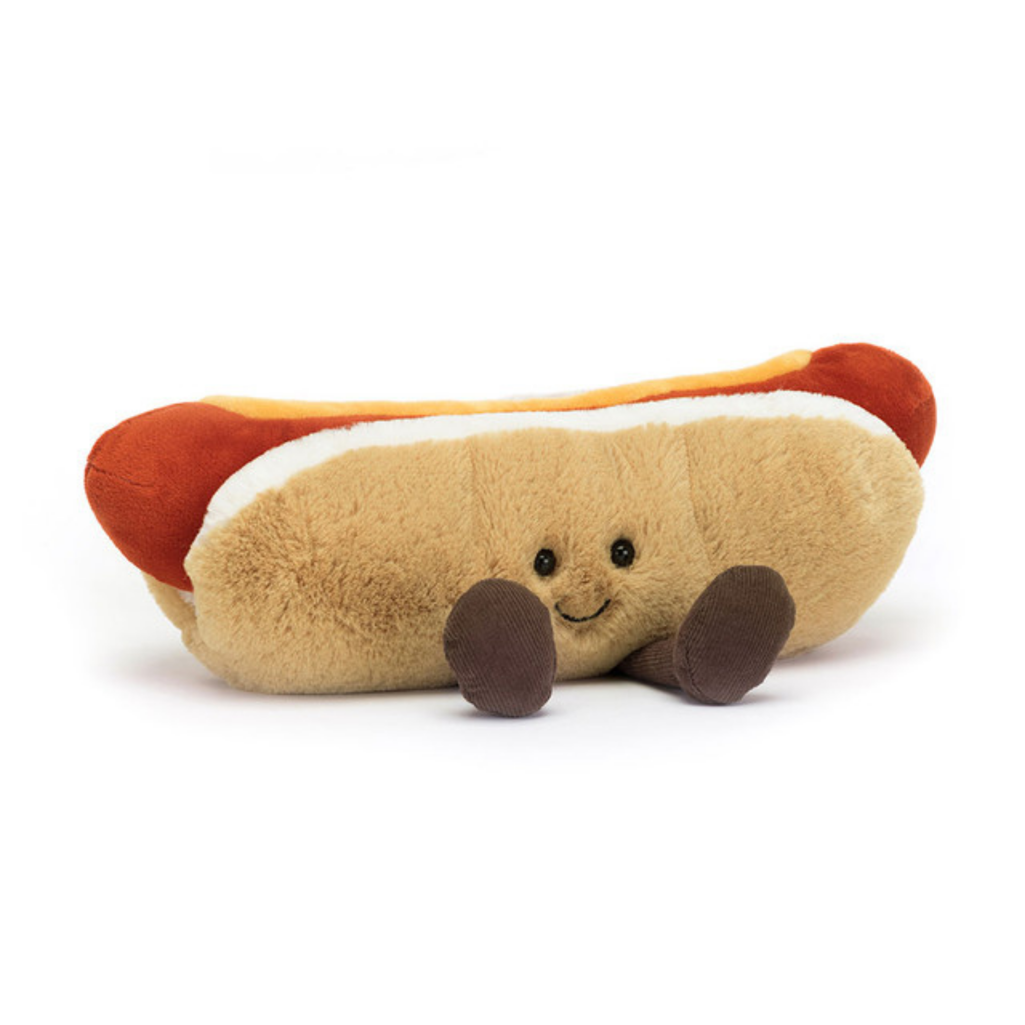 Jellycat Amuseables Hot Dog plush with smiling face, soft tan bun, red sausage, and brown cord legs, shown on white background.