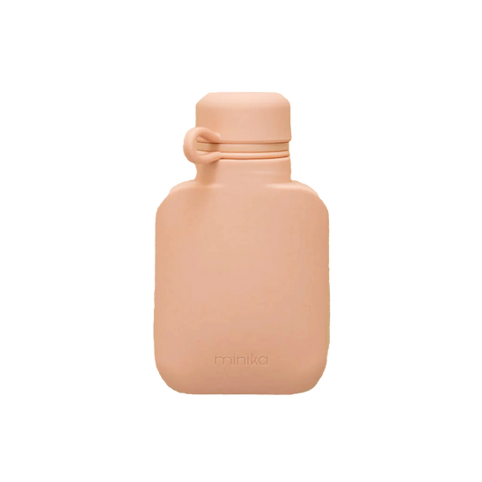 Soft peach silicone water bottle with rounded shape and matching screw cap, designed for toddlers and easy on-the-go hydration.