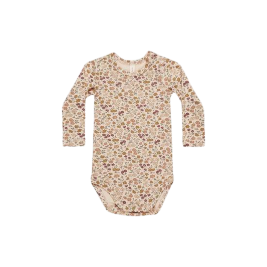 Long-sleeve baby bodysuit in light beige with an all-over floral pattern, featuring snap closures at the bottom for easy changing.