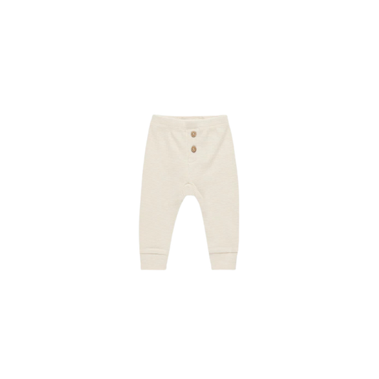 Quincy Mae baby leggings in natural beige with slim fit, elastic waistband, and three front buttons, made from soft organic cotton on white background.