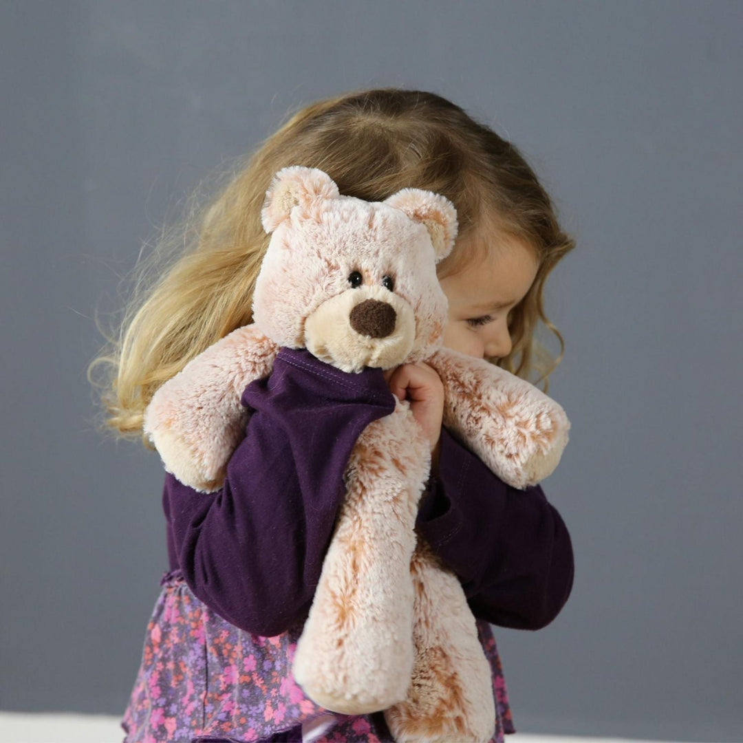 Young child hugging Mary Meyer Marshmallow Zoo teddy bear plush, highlighting its ultra-soft fabric and comforting companion design.